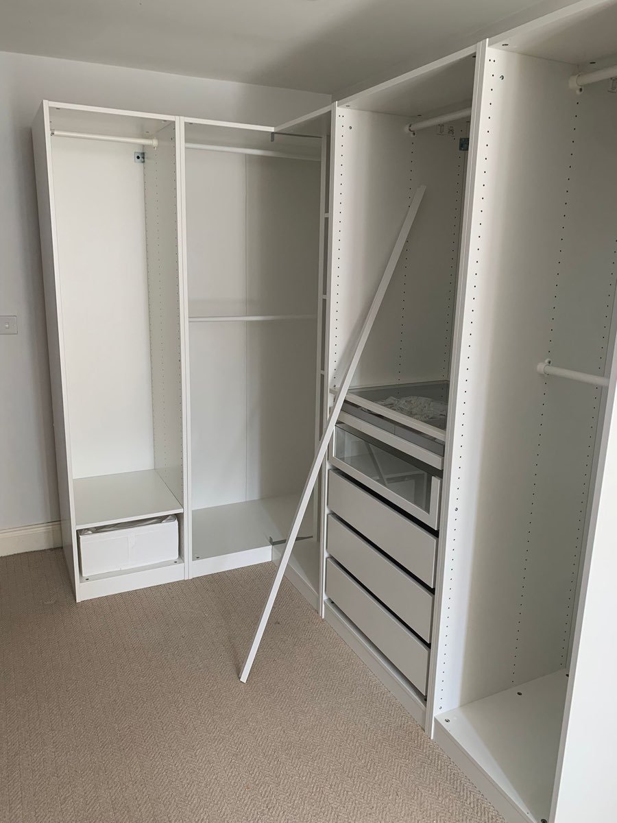 Floor-to-ceiling fitted wardrobes assembled in a bedroom